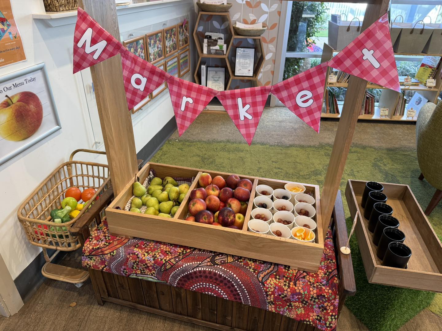 Creating a fruit market stall to give children the autonomy to pick their own healthy snack at Imagine Childcare and Preschool Blueridge Park
